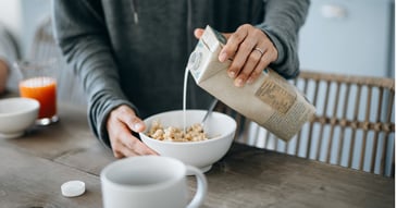 Person pours milk over pea protein crisp cereal