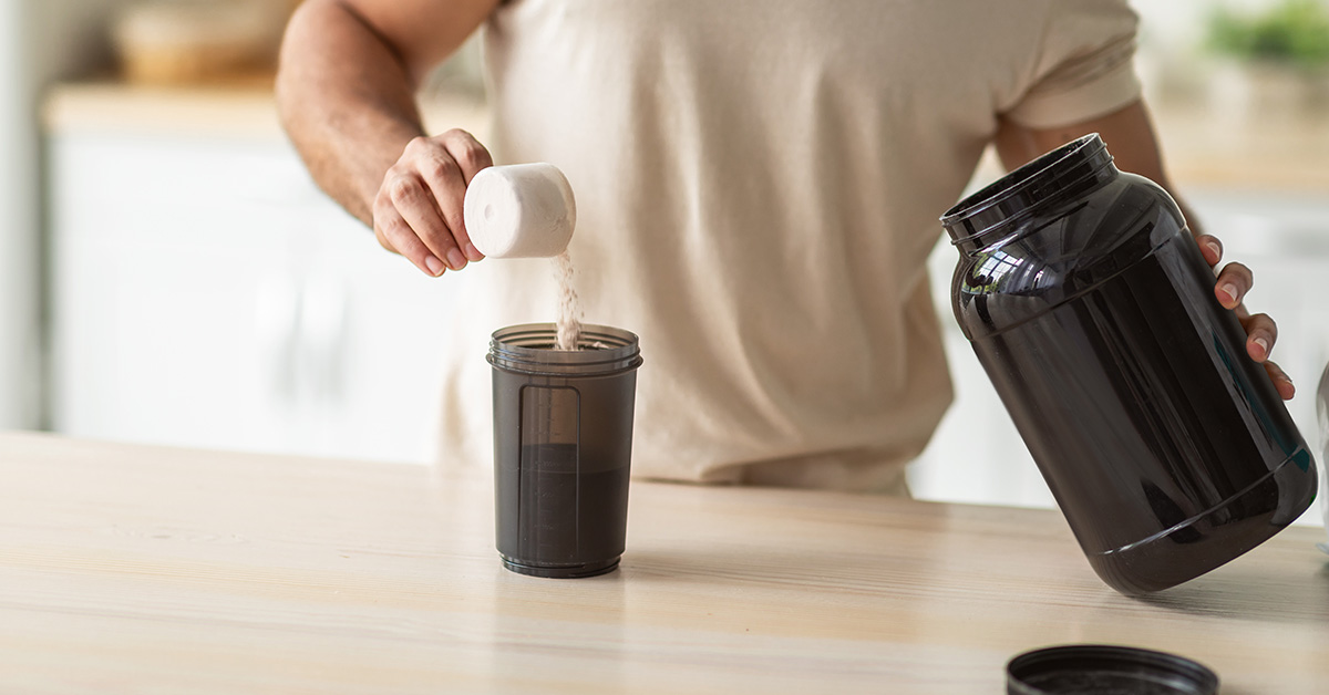 a man mixes his protein drink with protein powder